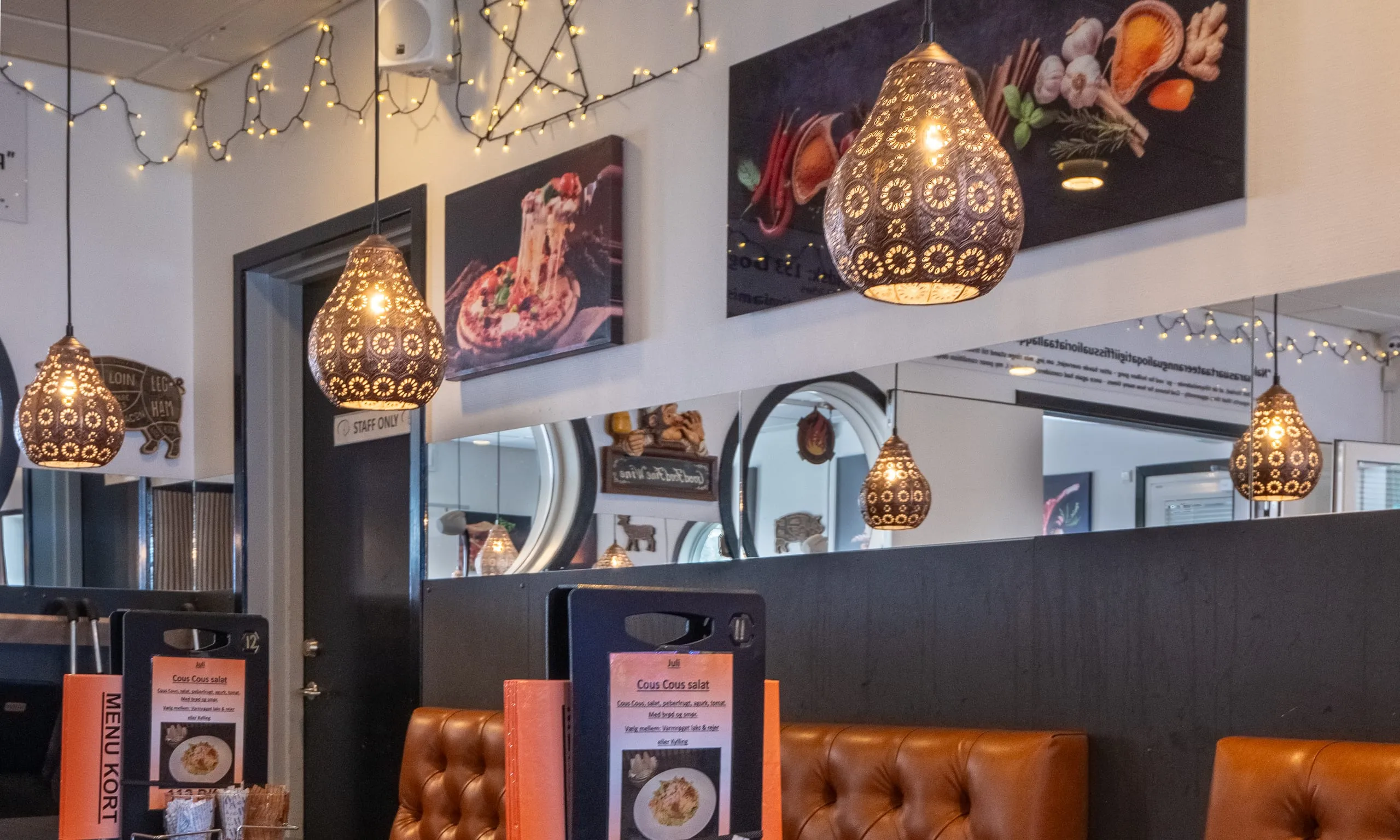 The brasserie: pierced copper lamps hanging over leather booths, with pictures of pizza and spices on the walls.